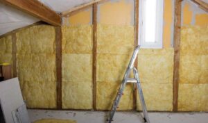 Open wall cavities showing freshly installed fiberglass insulation.