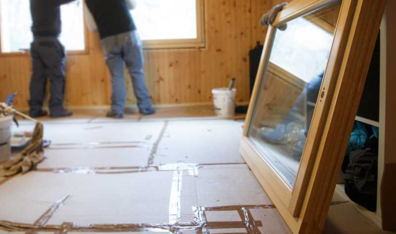 Workers installing new windows during a remodeling project.