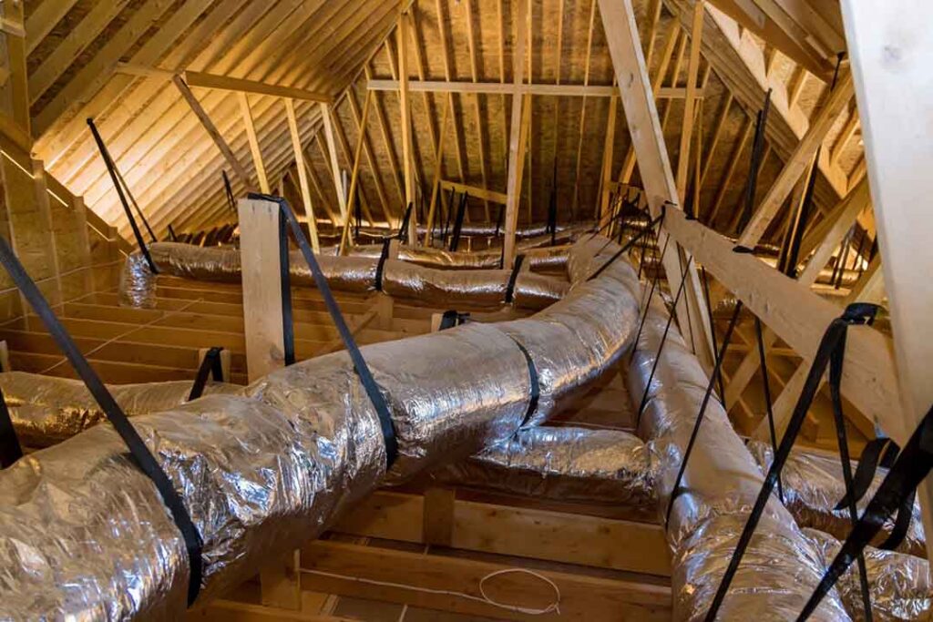 DeVere Insulation photo of insulated HVAC ductwork strapped to roof trusses in a vented Baltimore, MD attic.